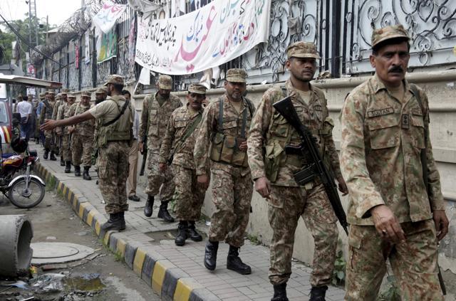 Soldiers arrive at the polling station to provide security to its staff in Lahore on July 24, 2018. (AP) Soldiers arrive at the polling station to provide security to its staff in Lahore on July 24, 2018. (AP)