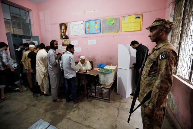 A soldier keeps watch as people vote at a polling station during the general election in Rawalpindi, Pakistan. (Reuters photo) A soldier keeps watch as people vote at a polling station during the general election in Rawalpindi, Pakistan. (Reuters photo)
