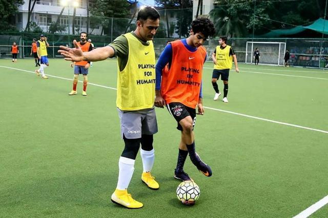 MS Dhoni (L) and Ishaan Khatter jostle for possession. (Twitter) MS Dhoni (L) and Ishaan Khatter jostle for possession. (Twitter)