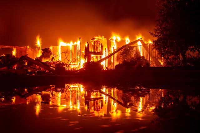 A burning home is reflected in a pool during the Carr fire in Redding, California on July 27. (AFP Photo) A burning home is reflected in a pool during the Carr fire in Redding, California on July 27. (AFP Photo)
