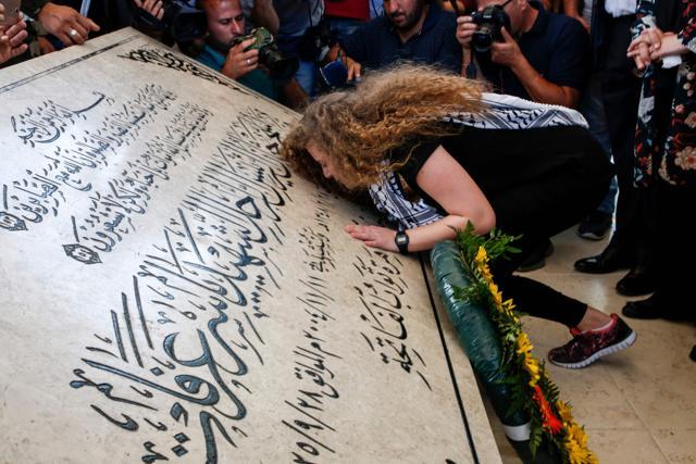 Palestinian activist and campaigner Ahed Tamimi kisses the tombstone of former Palestinian leader Yasser Arafat at his mausoleum in Ramallah in the occupied West Bank, on July 29, 2018, after she was released from prison earlier in the day following an eight-month sentence for slapping two Israeli soldiers. (AFP) Palestinian activist and campaigner Ahed Tamimi kisses the tombstone of former Palestinian leader Yasser Arafat at his mausoleum in Ramallah in the occupied West Bank, on July 29, 2018, after she was released from prison earlier in the day following an eight-month sentence for slapping two Israeli soldiers. (AFP)