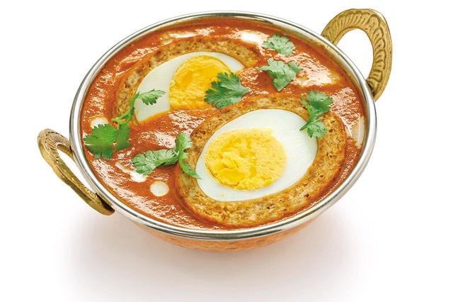 The original curry had a tomato gravy that was difficult to recreate in Britain (Shutterstock)