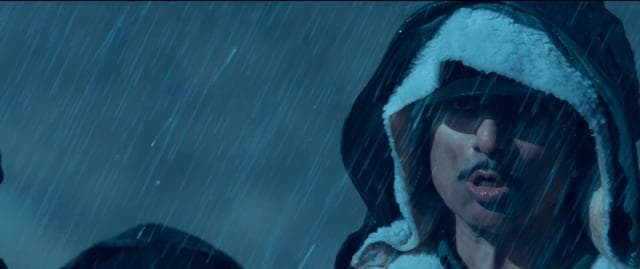 Sonu Sood lets the fake rain and blue tint wash over him.
