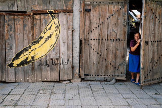 An elderly women leaves her house as a reproduction of the famous banana graphic by Andy Warhol is painted on the wall, during an annual open-air gallery event, dedicated this year to the New Yorks Museum of Modern Art (MoMA), in the village of Staro Zhelezare near Plovdiv, on August 4. (AFP Photo) An elderly women leaves her house as a reproduction of the famous banana graphic by Andy Warhol is painted on the wall, during an annual open-air gallery event, dedicated this year to the New Yorks Museum of Modern Art (MoMA), in the village of Staro Zhelezare near Plovdiv, on August 4. (AFP Photo)