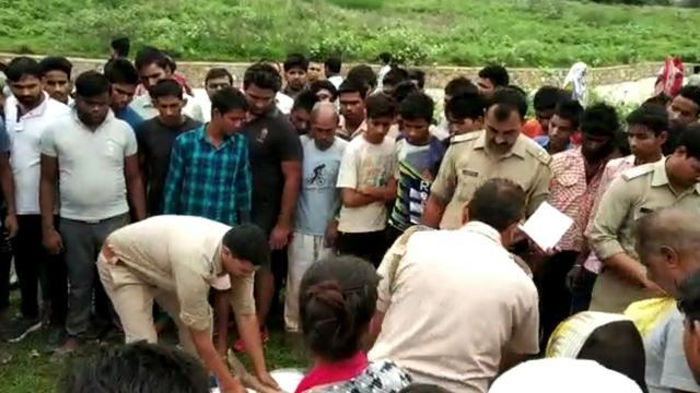 Police officials at the spot where the bodies of two 11-year-old boys were discovered from an abandoned pool. (HT Photo ) Police officials at the spot where the bodies of two 11-year-old boys were discovered from an abandoned pool. (HT Photo )