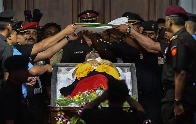 A Tri-colour is placed on the mortal remains of DMK chief M Karunanidhi at Rajaji Hall in Chennai on Wednesday. (PTI) A Tri-colour is placed on the mortal remains of DMK chief M Karunanidhi at Rajaji Hall in Chennai on Wednesday. (PTI)