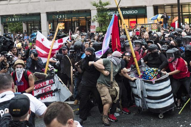 Demonstrators opposed to a far-right rally block a street as police try to dislodge them near the White House August 12, 2018 in Washington, DC, one year after the deadly violence at a similar protest in Charlottesville, Virginia. (AFP) Demonstrators opposed to a far-right rally block a street as police try to dislodge them near the White House August 12, 2018 in Washington, DC, one year after the deadly violence at a similar protest in Charlottesville, Virginia. (AFP)
