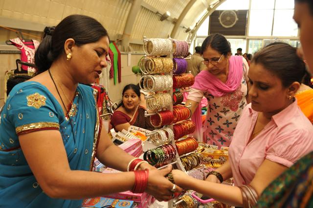 A bangle-seller makes a woman try bangles at Dilli Haat in Janakpuri. (Photo: Subrata Biswas/HT)