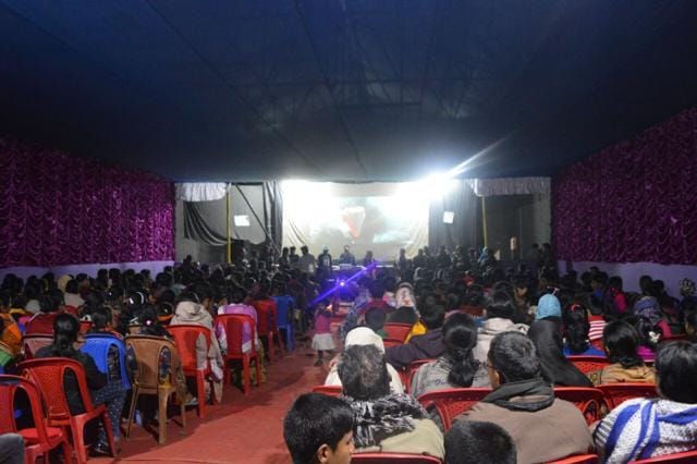 Aaideo’s setup is a portable 35 ft x 20 ft screen, a projector, a generator and a Blu-ray player that it takes from village to village in a lorry. Aaideo’s setup is a portable 35 ft x 20 ft screen, a projector, a generator and a Blu-ray player that it takes from village to village in a lorry.
