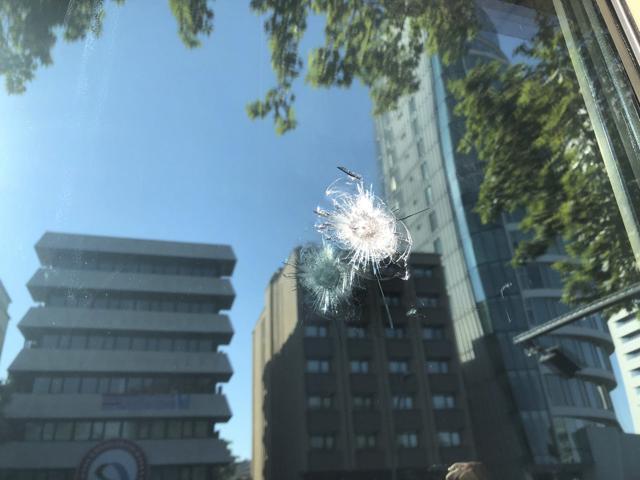 The damage to a security booth by a shot fired, is seen outside the US Embassy in Ankara, Turkey. (AP) The damage to a security booth by a shot fired, is seen outside the US Embassy in Ankara, Turkey. (AP)