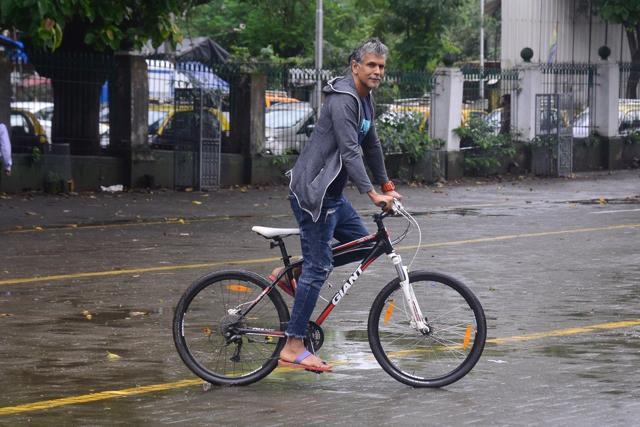Milind Soman goes cycling in rain at Q Experience event.