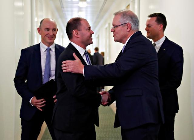 Incoming Australian Prime Minister Scott Morrison is congratulated by his new deputy Josh Frydenberg after a party meeting in Canberra, Australia August 24, 2018. (REUTERS) Incoming Australian Prime Minister Scott Morrison is congratulated by his new deputy Josh Frydenberg after a party meeting in Canberra, Australia August 24, 2018. (REUTERS)