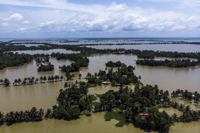 Trees and houses are partially submerged in floodwaters in this aerial photograph taken in Kainakary village in the district of Alappuzha, Kerala. (Bloomberg) Trees and houses are partially submerged in floodwaters in this aerial photograph taken in Kainakary village in the district of Alappuzha, Kerala. (Bloomberg)