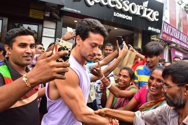 Tiger Shroff seems a bit uncomfortable with so many people around him.