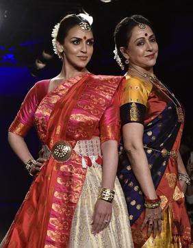 Hema Malini (R) with daughter Esha Deol (L) showcases a creation by designer Sanjukta Dutta. (AFP) Hema Malini (R) with daughter Esha Deol (L) showcases a creation by designer Sanjukta Dutta. (AFP)