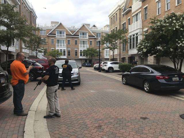 Federal authorities stage and search a home in Baltimores Inner Harbor as part of an investigation into the Jacksonville mass shooting. (AP Photo) Federal authorities stage and search a home in Baltimores Inner Harbor as part of an investigation into the Jacksonville mass shooting. (AP Photo)