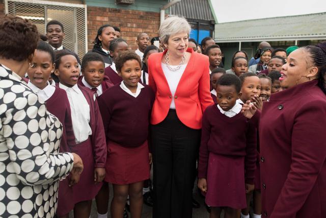 Britain's Prime Minister Theresa May poses with school children during a visit to the ID Mkhize Secondary School in Gugulethu, as part of a working visit to South Africa. (AFP) Britain's Prime Minister Theresa May poses with school children during a visit to the ID Mkhize Secondary School in Gugulethu, as part of a working visit to South Africa. (AFP)
