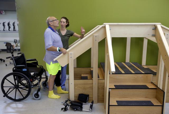 William Lytton left, is assisted by physical therapist Caitlin Geary as he prepares to climb a set of stairs at Spaulding Rehabilitation Hospital, in Boston. (AP Photo) William Lytton left, is assisted by physical therapist Caitlin Geary as he prepares to climb a set of stairs at Spaulding Rehabilitation Hospital, in Boston. (AP Photo)