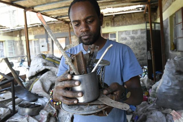 Kenyan "junk artist" Evans Ngure shows collected materials that he uses for his works at a dumpsite in Nairobi. (AFP) Kenyan "junk artist" Evans Ngure shows collected materials that he uses for his works at a dumpsite in Nairobi. (AFP)