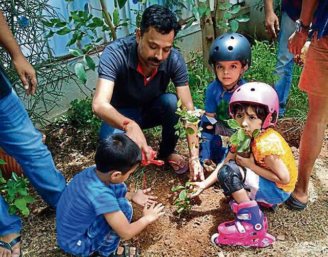 Children planting trees at Konark Eureka in Wadgaon Sheri during the plantation drive. (HT PHOTO) Children planting trees at Konark Eureka in Wadgaon Sheri during the plantation drive. (HT PHOTO)