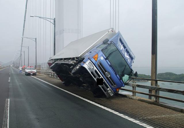 This handout photo released by the Kagawa Prefectural Police on September 4, 2018 and received via Jiji Press shows a truck sitting at an angle after being blown over by strong winds caused by Typhoon Jebi on the Seto Ohashi bridge in Sakade, Kagawa prefecture on Japan's Shikoku island. (AFP) This handout photo released by the Kagawa Prefectural Police on September 4, 2018 and received via Jiji Press shows a truck sitting at an angle after being blown over by strong winds caused by Typhoon Jebi on the Seto Ohashi bridge in Sakade, Kagawa prefecture on Japan's Shikoku island. (AFP)