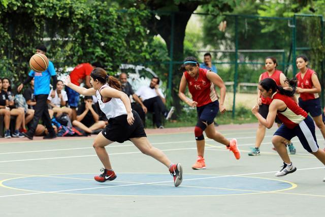 Players from Lady Shri Ram College for Women and Shri Ram College of Commerce competein a basketball match. (Amal KS/HT Photo)