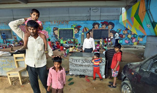 An informal classroom under the metro bridge Akshardham Mandir in New Delhi. Dozens of volunteers across Delhi running informal classrooms to help under-privileged students with basic education to enable them to get into formal schools. (Sushil Kumar/HT PHOTO) An informal classroom under the metro bridge Akshardham Mandir in New Delhi. Dozens of volunteers across Delhi running informal classrooms to help under-privileged students with basic education to enable them to get into formal schools. (Sushil Kumar/HT PHOTO)