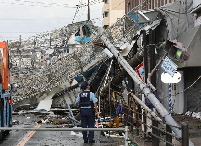 Damaged traffic boards and telecommunication relay poles are seen after they were brought down by strong winds caused by typhoon Jebi in Osaka on September 4, 2018. (AFP) Damaged traffic boards and telecommunication relay poles are seen after they were brought down by strong winds caused by typhoon Jebi in Osaka on September 4, 2018. (AFP)