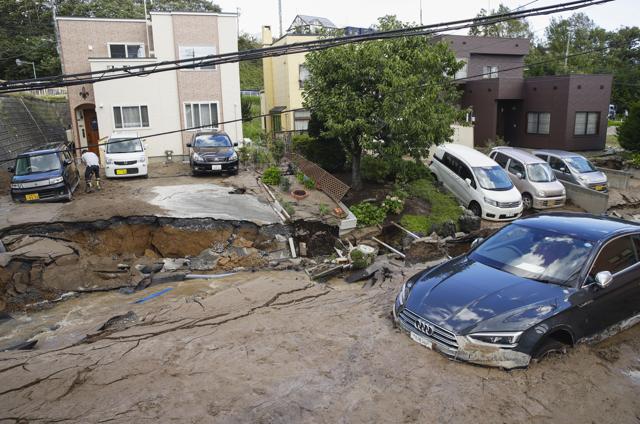 Cars are stuck in mud covered road after an earthquake in Sapporo, Hokkaido, northern Japan, Thursday, Sept. 6, 2018. (AP) Cars are stuck in mud covered road after an earthquake in Sapporo, Hokkaido, northern Japan, Thursday, Sept. 6, 2018. (AP)