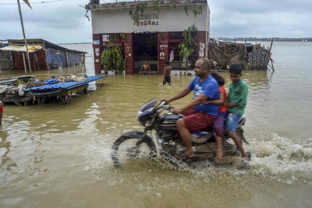 A biker rides across a flooded street after the water level in River Ganges crossed the danger mark following heavy rainfall at Daraganj area, in Allahabad, Wednesday, September 5, 2018. (PTI) A biker rides across a flooded street after the water level in River Ganges crossed the danger mark following heavy rainfall at Daraganj area, in Allahabad, Wednesday, September 5, 2018. (PTI)