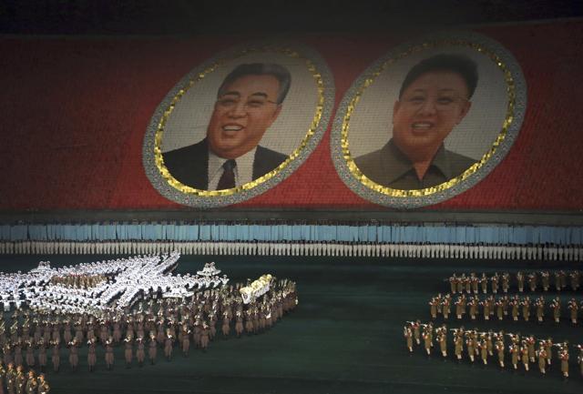 FILE - In this July 22, 2013, file photo, performers dance in front of portraits of late North Korean leaders Kim Il Sung, left, and Kim Jong Il in Pyongyang, North Korea. (AP)