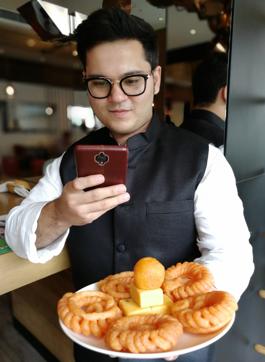 Karan Marwah takes a photo for his Instagram page, @foodelhi. Better tech has made it easier for youngsters to craft glossy social media posts. (Instagram ) Karan Marwah takes a photo for his Instagram page, @foodelhi. Better tech has made it easier for youngsters to craft glossy social media posts. (Instagram )