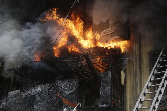 Fire breaks out of a window as firefighters try to extinguish at Bagree Market in Kolkata, India, Sunday, Sept. 16, 2018. (AP) Fire breaks out of a window as firefighters try to extinguish at Bagree Market in Kolkata, India, Sunday, Sept. 16, 2018. (AP)
