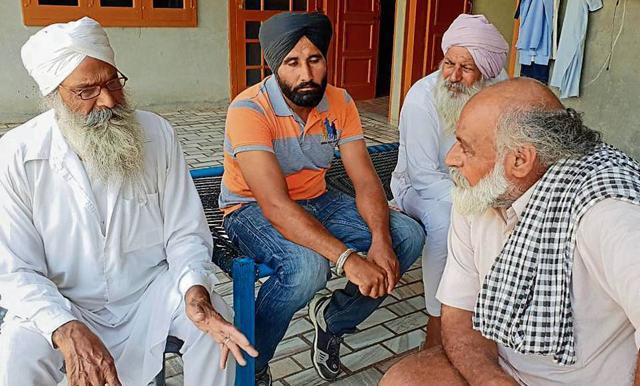 Jasbir Singh’s father Nirbhai Singh (right) being consoled by neighbours at his house in Barnala. (HT Photo) Jasbir Singh’s father Nirbhai Singh (right) being consoled by neighbours at his house in Barnala. (HT Photo)