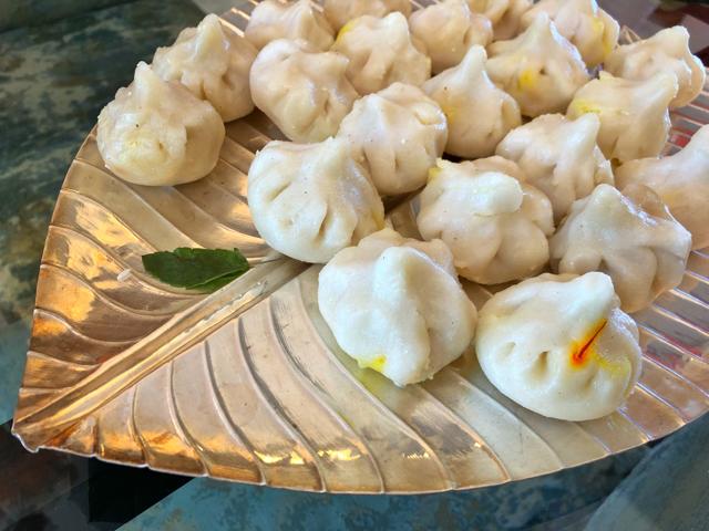 The Modaks were always a highlight, the fluffy rice dumplings filled with coconut cooked in sugar syrup with saffron and cardamom. The Modaks were always a highlight, the fluffy rice dumplings filled with coconut cooked in sugar syrup with saffron and cardamom.