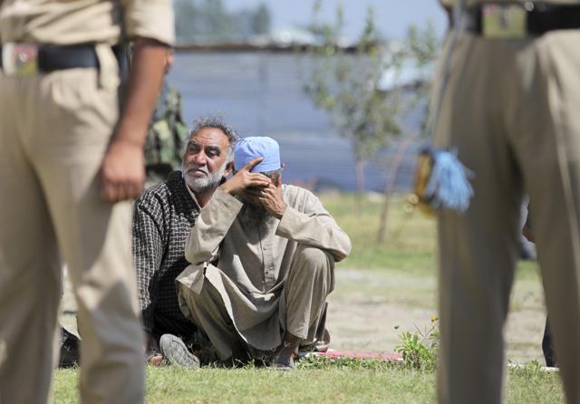 An unidentified relative of a slain policeman cries during a wreath laying ceremony at a base camp in Shopian. (AP Photo) An unidentified relative of a slain policeman cries during a wreath laying ceremony at a base camp in Shopian. (AP Photo)