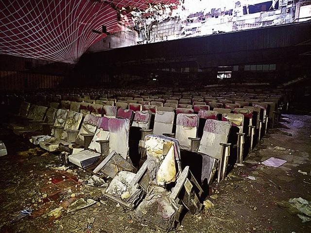 Under the seats on the first floor of the hall, next to the screen, are packets of chips left by the movie-goers on that fateful evening. The first floor suffered the most damage in the fire. (Sanchit Khanna / HT Photo)