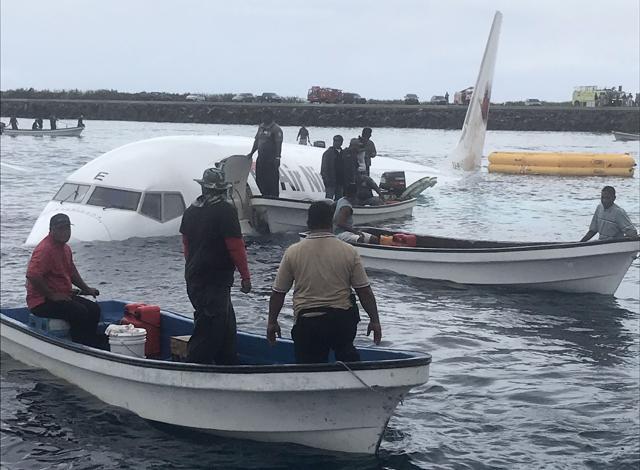 This photo taken by James Benito on September 28, 2018, shows locals approaching the crashed Air Niugini aircraft on the remote Island of Weno, in Micronesia. (AFP) This photo taken by James Benito on September 28, 2018, shows locals approaching the crashed Air Niugini aircraft on the remote Island of Weno, in Micronesia. (AFP)