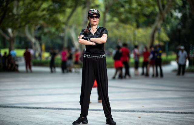 A woman from a square dancing team striking a pose for a photograph in a public park in Shanghai. (AFP) A woman from a square dancing team striking a pose for a photograph in a public park in Shanghai. (AFP)