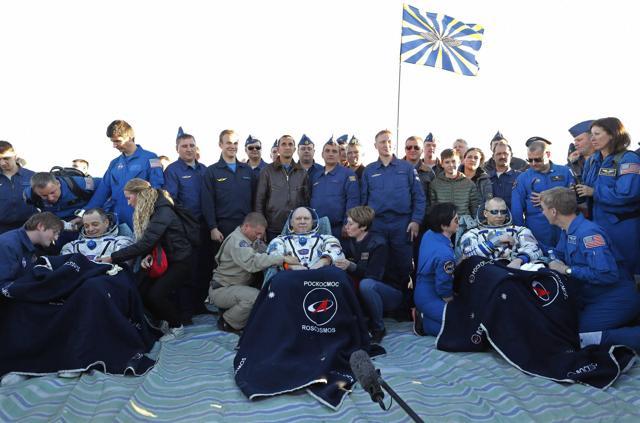 US astronaut Richard Arnold, left, Russian cosmonaut Oleg Artemyev, center, and US astronaut Andrew Feustel sit shortly after the landing of the Russian Soyuz MS-08 space capsule about 150 km (80 miles) south-east of the Kazakh town of Dzhezkazgan, Kazakhstan, Octovber 4, 2018. (AP)