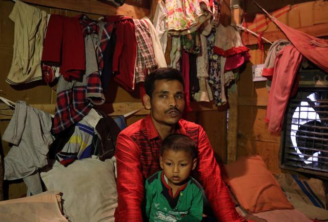 Sahidullah, a man from the Rohingya community, holds his son on his lap as he speaks with Reuters inside his shack at a camp on the outskirts of Jammu October 5, 2018. (REUTERS) Sahidullah, a man from the Rohingya community, holds his son on his lap as he speaks with Reuters inside his shack at a camp on the outskirts of Jammu October 5, 2018. (REUTERS)