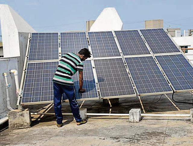 Solar panels set up on the terrace of one of the society buildings. (HT PHOTO) Solar panels set up on the terrace of one of the society buildings. (HT PHOTO)