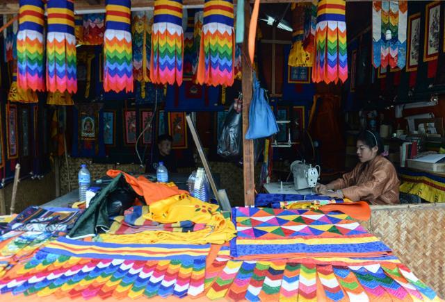 A vendor works at a stall at Nozrin Lam local market in the Bhutanese capital Thimphu.. (AFP Photo) A vendor works at a stall at Nozrin Lam local market in the Bhutanese capital Thimphu.. (AFP Photo)