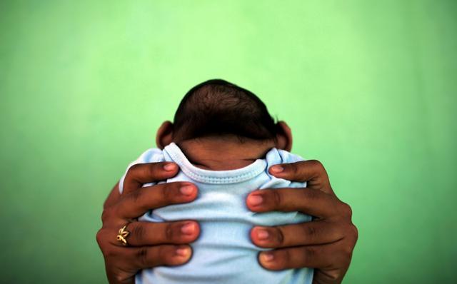 A mother hold up her four-month-old son who was born with microcephaly. (Reuters) A mother hold up her four-month-old son who was born with microcephaly. (Reuters)