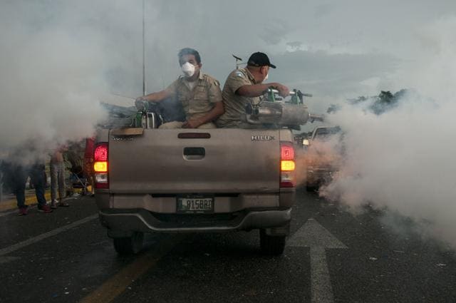 Guatemalan Health Minister workers fumigate on a bridge that stretches over the Suchiate River connecting Guatemala and Mexico, in Tecun Uman, Guatemala, Sunday, Oct. 21, 2018. Guatemala's migration agency confirmed that another group of about 1,000 migrants crossed into the country from Honduras on Sunday. (Oliver de Ros/AP Photo) Guatemalan Health Minister workers fumigate on a bridge that stretches over the Suchiate River connecting Guatemala and Mexico, in Tecun Uman, Guatemala, Sunday, Oct. 21, 2018. Guatemala's migration agency confirmed that another group of about 1,000 migrants crossed into the country from Honduras on Sunday. (Oliver de Ros/AP Photo)