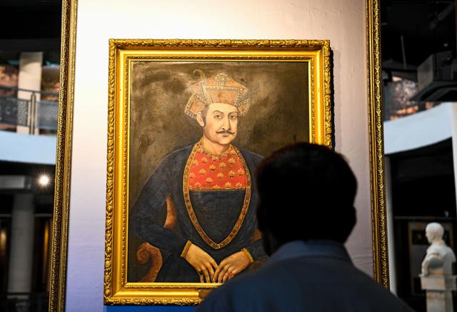A man looks at a painting displayed inside the Rashtrapati Bhavan museum in New Delhi. (AFP)