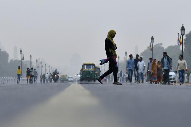 A pedestrian crosses a road in New Delhi. (Bloomberg File) A pedestrian crosses a road in New Delhi. (Bloomberg File)