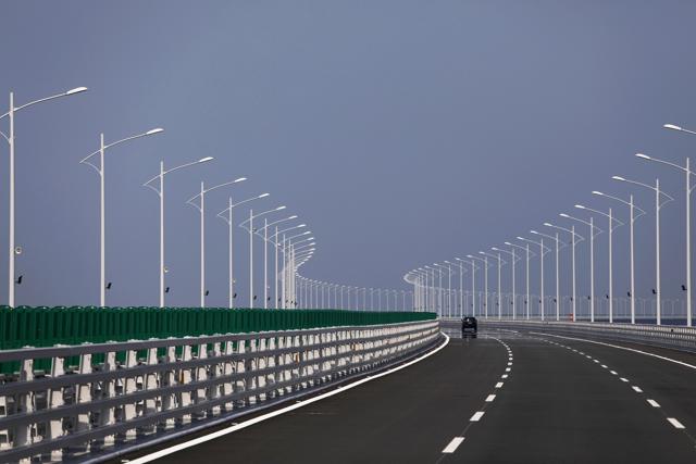 A vehicle travels along a section of the bridge. (Bloomberg) A vehicle travels along a section of the bridge. (Bloomberg)