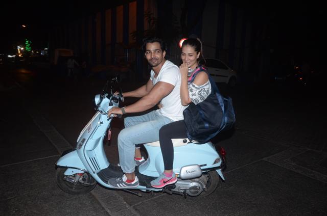 Harshvardhan Rane and Kim Sharma ride a scooter in Mumbai.