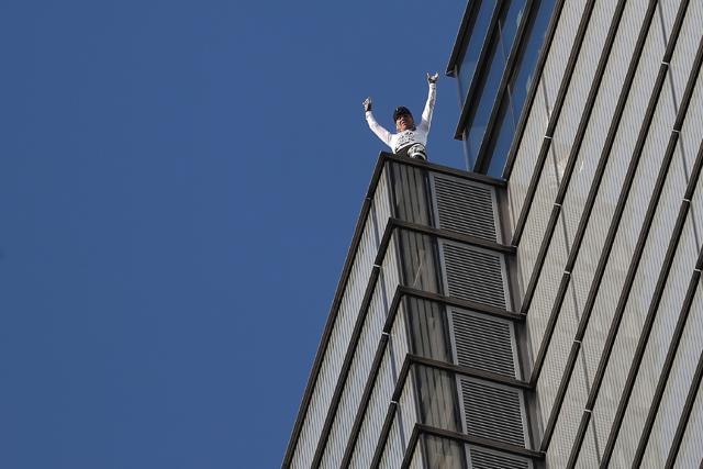 French urban climber Alain Robert reacts as he reaches the top of Heron. (AFP) French urban climber Alain Robert reacts as he reaches the top of Heron. (AFP)